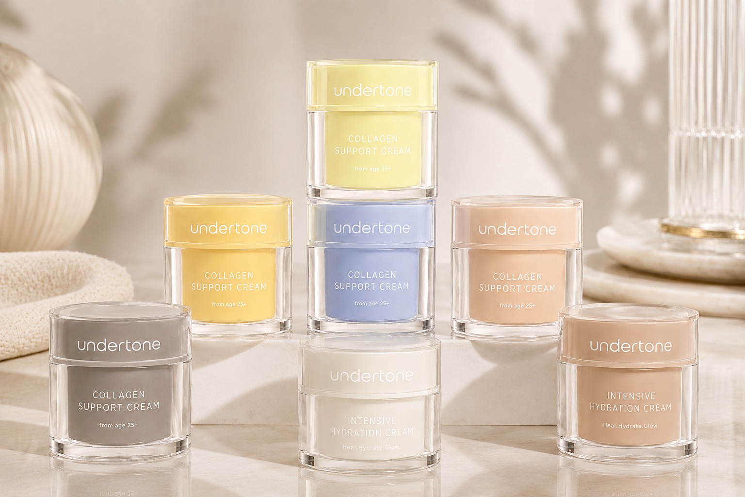Undertone jars in pastel tones arranged on a warm stone surface